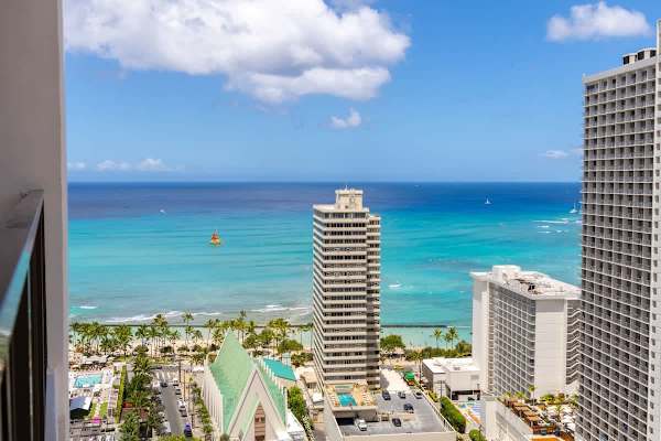 Experience beautiful ocean and city views from your private balcony, capturing the vibrant essence of Hawaii.