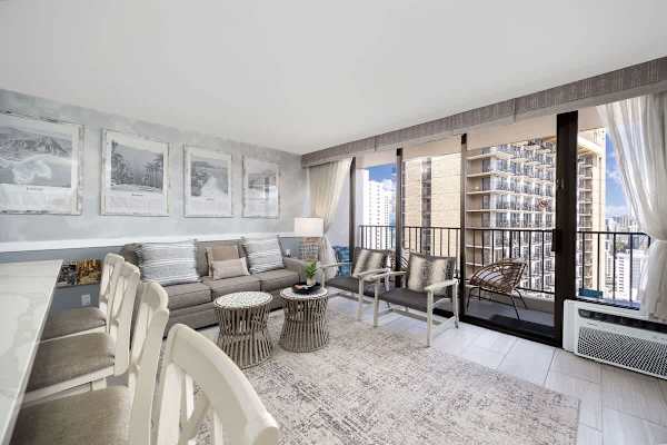 Relax and enjoy the views from this bright and inviting living room, featuring a pull-out sleeper sofa and direct access to a private balcony.