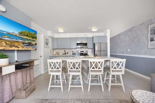 Modern and fully-equipped kitchen with a spacious island and bar seating, perfect for cooking and entertaining.