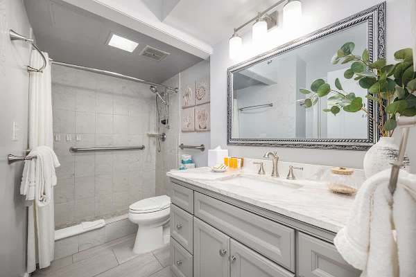 Indulge in a refreshing escape with this beautifully appointed bathroom featuring a walk-in shower and vanity, ensuring your comfort and convenience.