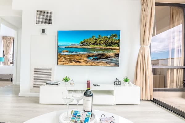 Enjoy movie nights on the impressive 65-inch smart TV, a focal point of the comfortable living area, with easy access to your balcony.