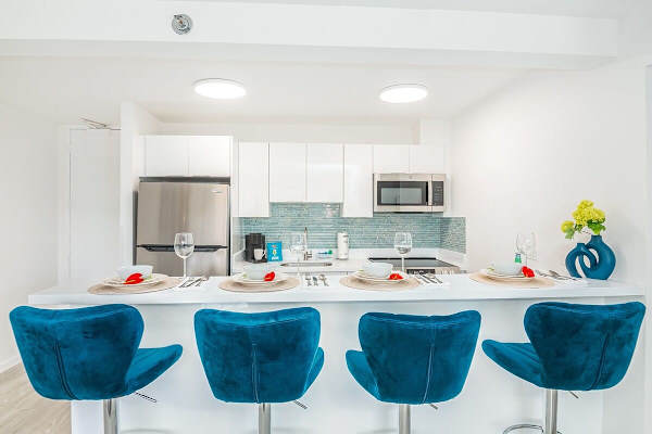 Dine in style at the modern breakfast bar, seamlessly integrated into the fully equipped kitchen, offering a chic and convenient space for meals and conversation.