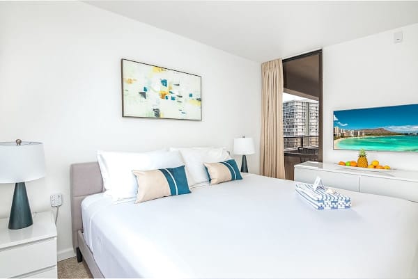 Relax in the tranquil main bedroom, featuring a plush king-sized bed, a closet, and a 43" smart TV for entertainment.