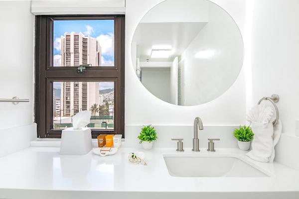 Bathroom with wall mounted mirror and cabinet