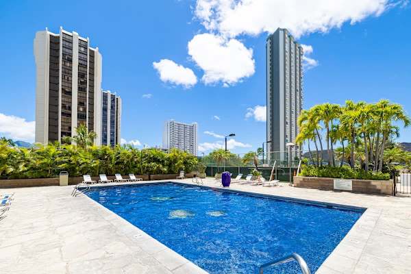 Dive into relaxation at our inviting pool, surrounded by lush palms and the vibrant energy of the city skyline.