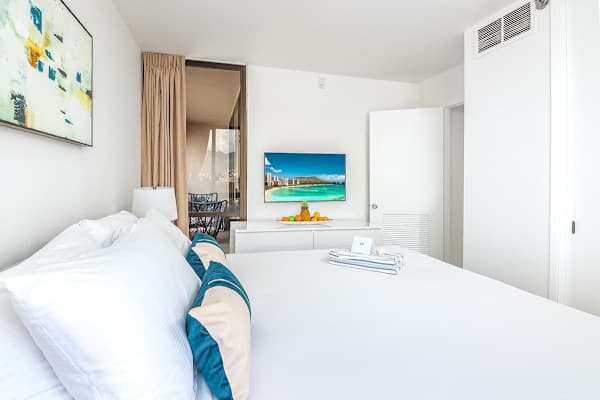 Relax in the tranquil main bedroom, featuring a plush king-sized bed, a closet, and a 43" smart TV for entertainment.