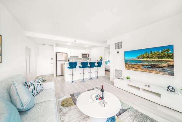 Relax and enjoy your favorite shows and movies on the 65-inch smart TV in the comfortable living area, perfectly complemented by the open-concept design and stylish kitchen.