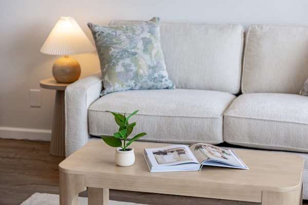 Enjoy a moment of relaxation in this inviting living space, complete with a stylish coffee table.