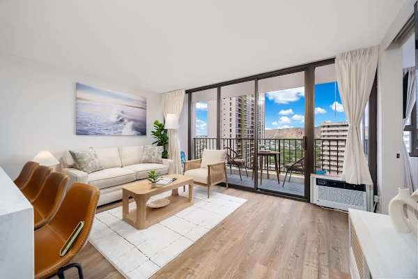 Relax in this bright living room, featuring a pull-out sleeper sofa, stylish coffee table, and direct access to a balcony with stunning views.
