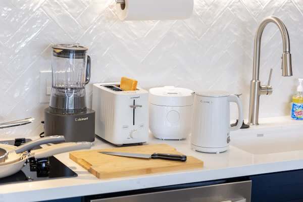Whip up anything from toast to smoothies with this kitchen's convenient collection of Cuisinart appliances, including a toaster, blender, and electric kettle.