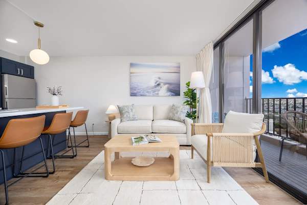 Relax in this bright living room, featuring a comfortable sofa, stylish coffee table, and direct access to a balcony with stunning views.
