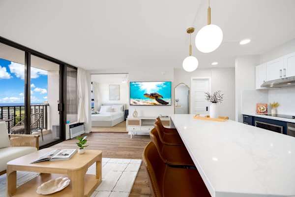 This open-concept condo offers a bright and airy living space and a modern kitchen with island seating, all with easy access to a private balcony boasting stunning views.