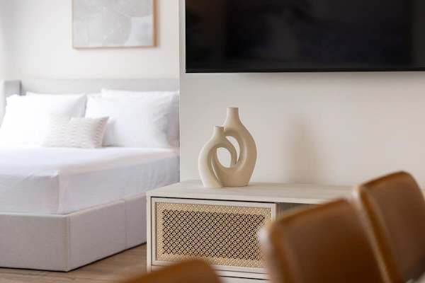 Add a touch of contemporary elegance to your space with this unique swirling vase, perfectly complementing the sleek media console.