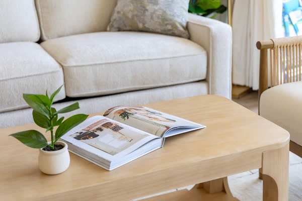 Enjoy a moment of relaxation in this inviting living space, complete with a stylish coffee table.