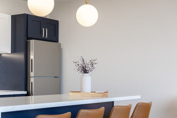This modern kitchen island offers a stylish space for dining or entertaining, complete with globe pendant lights.