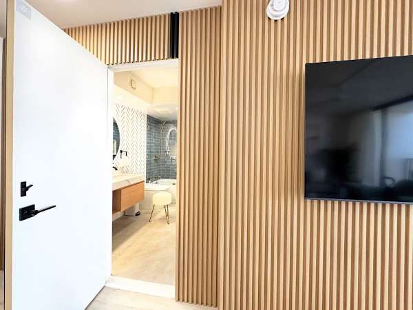 Unveil a touch of mystery! This space combines sophisticated modern design with a unique twist—a secret door leading to your luxurious and stylish bathroom.