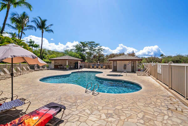 Lounge the day away around the beautiful, inviting pool with its surrounding stone deck, set amidst palm trees and complete with a nearby hot tub and covered BBQ/grill area for the perfect sunny afternoon.