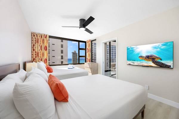 The bedroom features 2 Queen beds, a 46" Sony TV for cozy viewing, and large windows offering scenic city and partial ocean views!