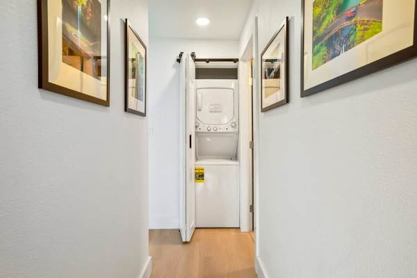 Enjoy the convenience of an in-unit stacked washer and dryer, discreetly tucked away in the hallway closet for all your laundry needs during your stay.