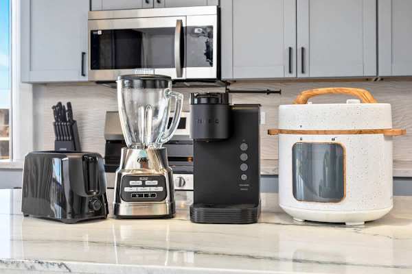 Whip up any meal or beverage with ease thanks to the well-stocked kitchen counter, featuring a toaster, blender, and Keurig coffee maker.