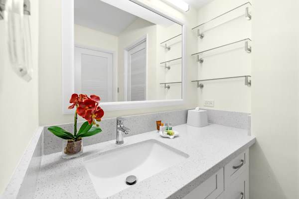 The bathroom has a vanity with cabinet!