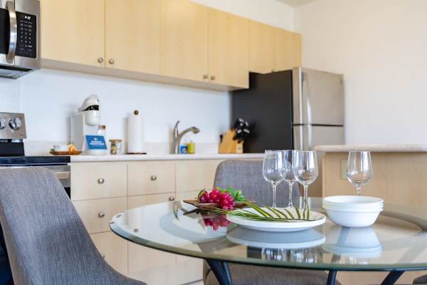 Savor a meal or a glass of wine at the modern dining table, conveniently located next to the fully-equipped kitchen.