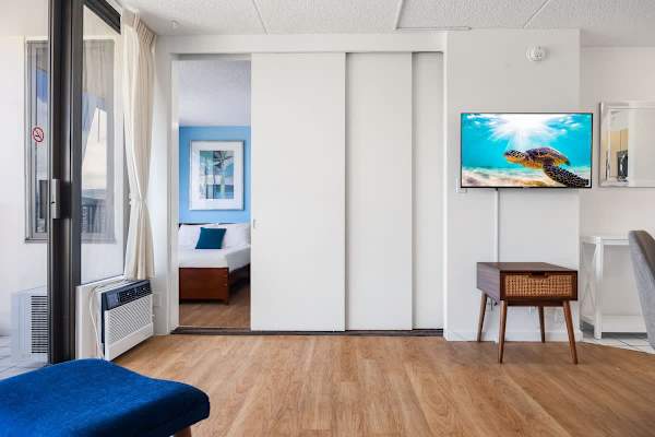Achieve privacy by closing the modern sliding door, separating the bedroom from the living area.