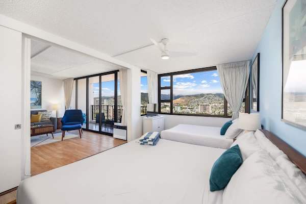 Relax in this bright bedroom with 1 king bed and 1 full bed, a convenient sliding door for privacy, and stunning mountain views from your window.
