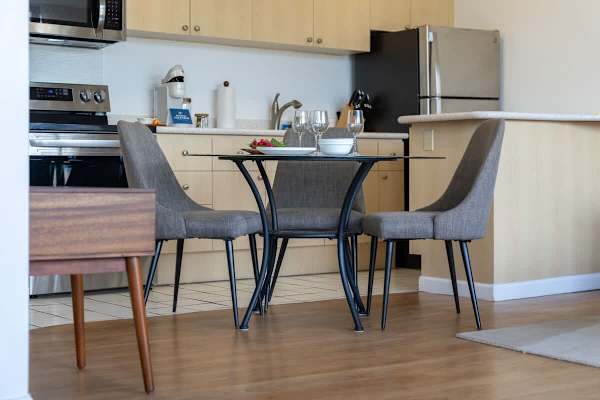 Savor a meal or a glass of wine at the modern dining table, conveniently located next to the fully-equipped kitchen.
