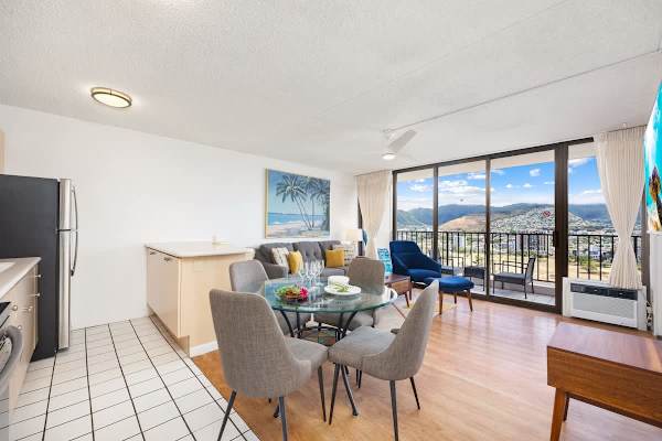 Relax in the bright, modern living space that flows seamlessly from the kitchen and dining area to the balcony, offering stunning panoramic mountain views.