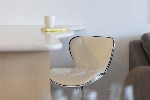 Enjoy a quick bite or morning coffee at the convenient breakfast bar with a comfortable and modern stool.
