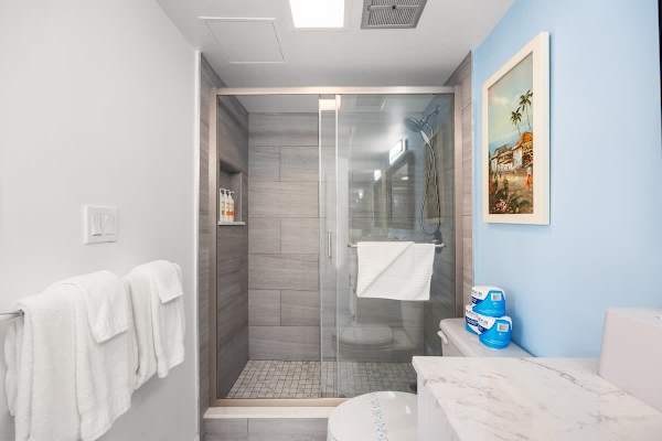 Indulge in the newly updated bathroom featuring a walk-in shower and modern vanity.