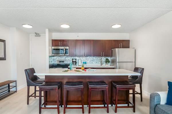 Kitchen dining countertop with 6 bar stools for shared meals.