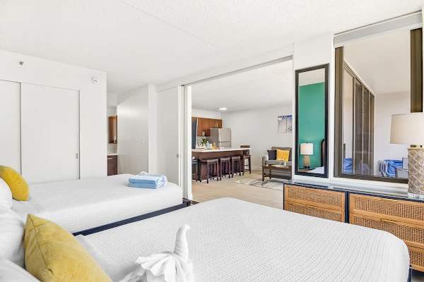 Bedroom with 2 queen beds and a sliding door that separates from the living room for privacy.