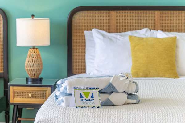 Towels and nightstand in the bedroom.