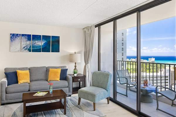 Pull-out sleeper sofa, accent chair, and coffee table in the living room with stunning ocean view.