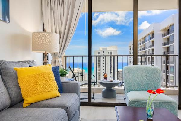 Pull-out sleeper sofa, accent chair, and coffee table in the living room with stunning ocean view.