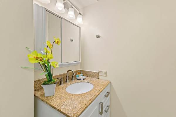 Full bathroom with cabinet.