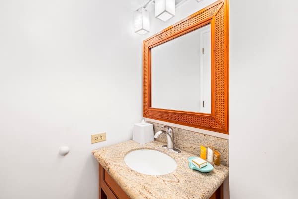 The bathroom has vanity with cabinet