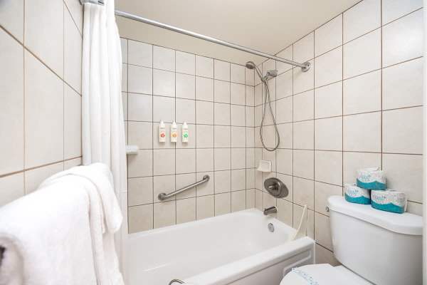 Refresh and rejuvenate in your bathroom, featuring a convenient shower/tub combo and complimentary toiletries for a hassle-free stay.