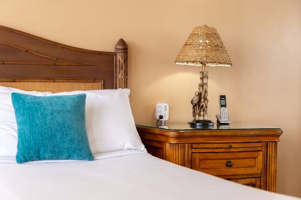 Unwind in comfort with bedside essentials like a charming lamp and convenient charging ports for all your devices.