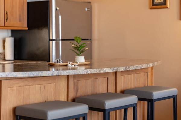 Enjoy casual dining or morning coffee at the stylish breakfast bar, perfectly situated in this inviting open-concept living space.