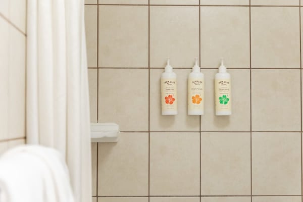Indulge in a tropical escape with complimentary Hawaiian Tropic bath amenities, ensuring a refreshing and luxurious shower experience during your stay.