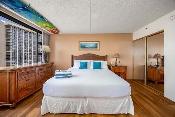 Indulge in ultimate comfort in your bedroom featuring a king-size bed, offering stunning direct ocean views from your window. The bedroom is separated from the living room by a sliding door.