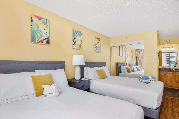 Bedroom with 1 full-size and 1 queen-size bed, closet, and access to the bathroom.