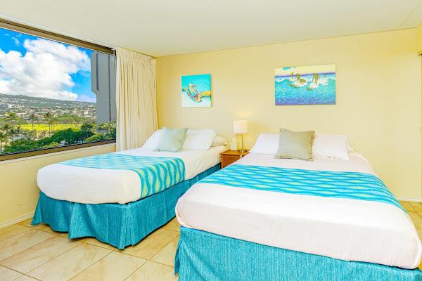 Bedroom with one full-size and one queen-size bed