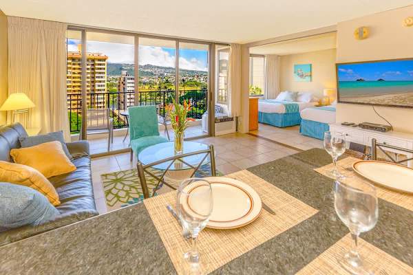 1 bedroom condo with beautiful mountain and city views, living room with open kitchen, window AC and reclining sleeper sofa, bedroom with 1 queen size and 1 full size bed.