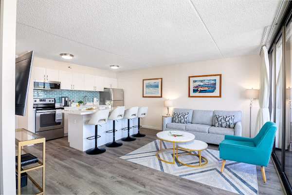Modern open-concept living area with a fully equipped kitchen and bright seating space.
