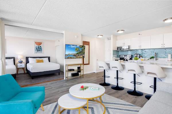 Modern open-concept living space with a fully equipped kitchen and comfortable seating.
