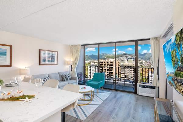 Modern living room with balcony and mountain views